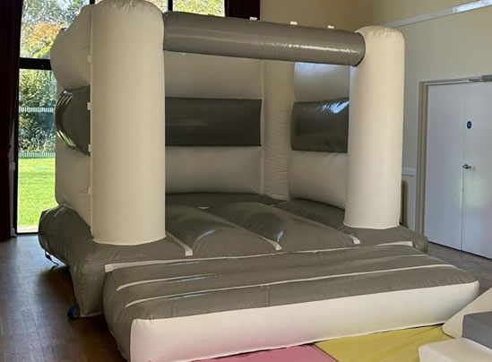 grey white bouncycastle hire